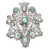 An emerald and diamond palladium silver pendant / brooch.