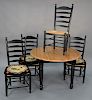 A five piece set to include a round pine table and four ladder back chairs. ht. 30 in., dia. 45 in., made in Italy.