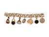 A 14 Karat Yellow Gold Bracelet With Seven Attached Fobs and Charms,