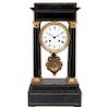 PORTICO MANTEL CLOCK. FRANCE, 19TH CENTURY. Ebonised wood with bronze and brass details. Winding mechanism.