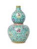 A Turquoise Ground Famille Rose Porcelain Gourd-Form Vase
Height 10 3/4 in., 27 cm. 