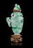 A Mottled Green Jadeite 'Dragon' Covered Vase
Overall: height 8 3/8 in., 21 cm. 