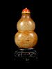 A Russet and Celadon Jade Double-Gourd Form Snuff Bottle
Height 2 1/2 in., 6 cm. 