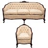 Conjunto de sillón y sofá. Siglo XX. Estructura de madera tallada con tapicería color beige. Con respados capitonados.Pz: 2