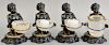 Set of four polychrome cast metal blackamoor candlesticks having kneeling figure supporting a ring and a glass vessel. ht. 6 1/2 in.