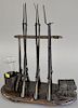 A French bronze desk ornament modeled as a gun rack with six bayoneted rifles, a regimental drum and two tomes, as is. ht. 13 in., w...