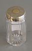 Crystal bottle having silver top center with gold monogrammed with crown. ht. 4 in.
