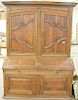 Regence provincial oak and fruitwood bureau a deux corps, the stepped rectangular cornice over a pair of wide hinged doors opening t...