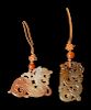 Two Chinese Russet and Celadon 'Dragon' Pendants
Larger: width 3 in., 7.6 cm.