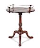 A Chippendale Style Mahogany Tilt-Top Tea Table
Height 30 x diameter 23 3/4 inches.