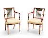A pair of George III style satinwood armchairs