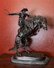 An American Bronze Figural Group, After Frederic Remington (1861-1909) Height overall 24 inches.