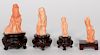 Four Chinese Carved Pink Coral Figures on Stands