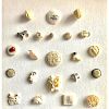 A GROUPING OF NATURAL MATERIAL BUTTONS