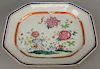 A Chinese export Famille Rose oblong octagonal platter, interior with a lush scene of blooming chrysanthemum, peony and other flowers between concentr