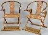 Pair of horseshoe folding/campaign armchairs, China 19th/20th century, possibly Huanghuali wood, with brass fittings, slatted seats and archaic dragon