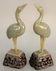 Pair of Chinese green gray jade cranes, having raised head and standing on square jade base mounted on carved wood elevated base, repaired legs. total