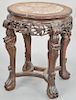 Marble inlaid circular taboret, China 19th century, with ornately carved apron and zoomorphic legs ending in ball and claw feet, the top inlaid with o