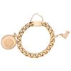 A yellow gold 21. 6 K, 18 K and 14 K bracelet with demonetized  coin and pendant.