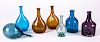 Seven reproduction glass bottles
