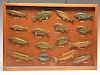 Wall display case with 16 fresh water fish carvings.