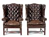 A Pair of George II Brown Leather Upholstered Wing ChairsHeight 32 inches.