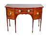  A George III Inlaid Mahogany Bow-front Sideboard
Height 37 1/2 x width 52 1/4 x depth 27 inches.
