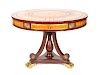 A Regency Style Gilt Metal Mounted Mahogany Drum Table
Height 28 1/4 x diameter 39 1/2 inches.