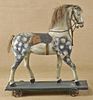 Carved and painted horse pull toy, 27'' h., 24'' l.