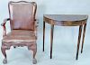 Two piece lot to include Chippendale style mahogany armchair with leather seat and back on hairy claw feet along with mahogany inlaid demilune table.