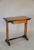 An English yew wood writing table and oval mirror with banded top over a single drawer, on trestle supports, late 19th/20th century. table ht. 28 in.,