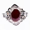 AN 18CT WHITE GOLD, RUBY AND DIAMOND RING, the oval cabocho
