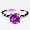 AN 18CT WHITE GOLD AND PURPLE SAPPHIRE RING, the round cut 