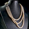 A CULTURED PEARL, RUBY AND DIAMOND NECKLACE, the three grad