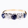 A SAPPHIRE AND DIAMOND 18CT YELLOW GOLD RING, the three rou