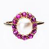 A CULTURED PEARL AND RUBY RING, the single cultured pearl r