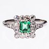 AN EMERALD AND DIAMOND RING, the square cut emerald set wit