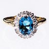 A 9CT YELLOW GOLD, BLUE TOPAZ AND DIAMOND CLUSTER RING, the