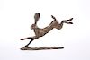 A CONTEMPORARY BRONZE OF A HARE, modelled running with back