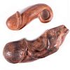 Two carved wooden phalluses.