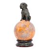 Bronze dog on marble stand.