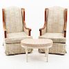 Par de sillones y taburete. Siglo XX. En talla de madera. Con respaldos cerrados y asientos en tapicería rayada y floreada.