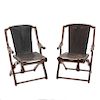 Par de sillas "Sling". México. Años 70. Diseño Don S. Shoemaker. En talla de madera tropical. Con respaldo y asiento en piel negra.