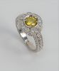 14 Karat White Gold Ring Set with Canary Yellow Diamond, approximately 1 carat, surrounded by small diamonds. size 6 1/4 inches.