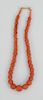 Red Coral Necklace, having gold clasp and faceted carved barrel beads of varying sizes. 13.9 millimeters - 7.45 millimeters plus small round beads len