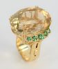 18 Karat Gold Cocktail Ring, with large oval stone flanked by five green stones, adjustable size. large stone 23.7millimeters x 30 millimeters.