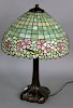 Handel Leaded Glass Table Lamp, having band of pink and yellow with double pansies encircling the shade with green leaves and brown sticks surrounding