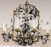 Rare Louis XV Tole and Gilt Metal Chandelier, mounted with porcelain flowers, gilt metal cage work surrounded by numerous tole vines fitted with polyc