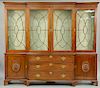 George III Style Mahogany Breakfront Bookcase, with stopped cornice above four glazed doors, over three long drawers flanked by doors decorated with r