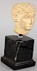 Ancient Roman Carved Stone Bust, possibly caracalla on black marble pedestal base. height 7 1/2 inches.